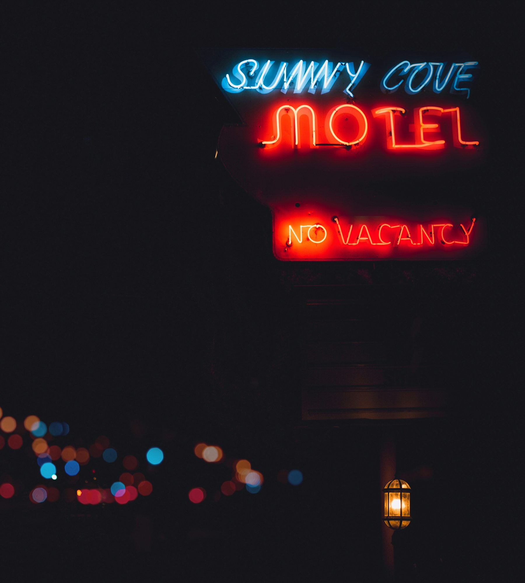 A red neon motel sign glowing at night.