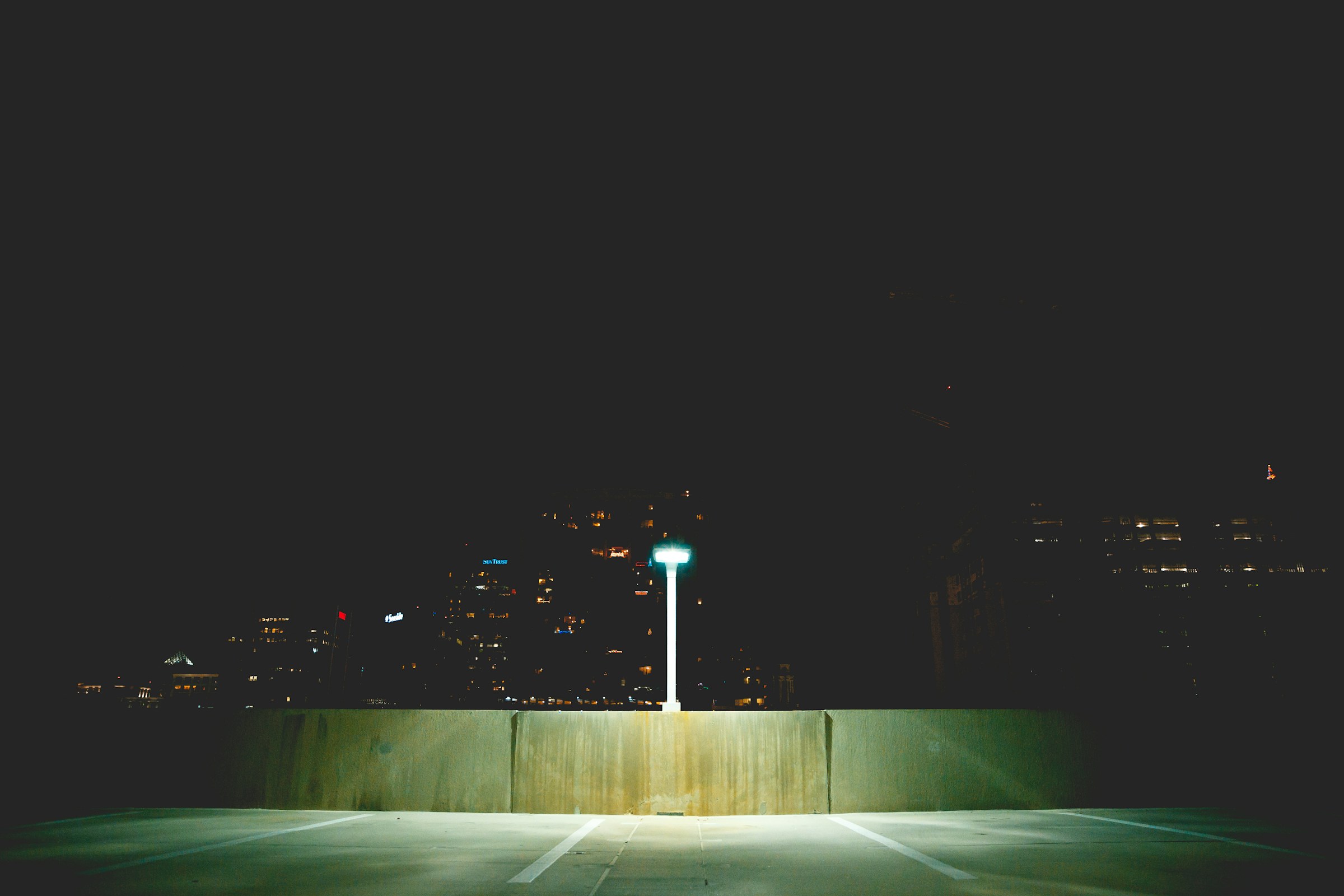 An empty Orlando parking area at night under street lights.