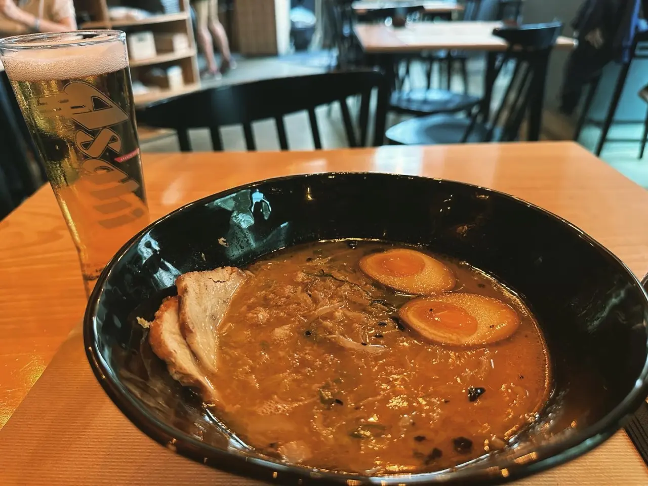 Photo of a bowl of ramen and a beer