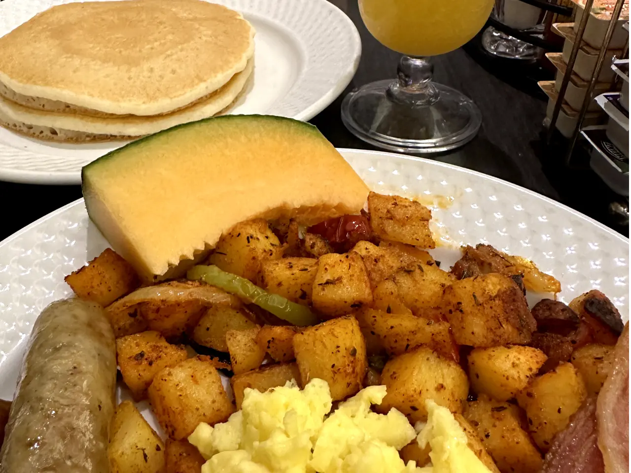 Photo of eggs, bacon, potatoes, pancakes and mimosas