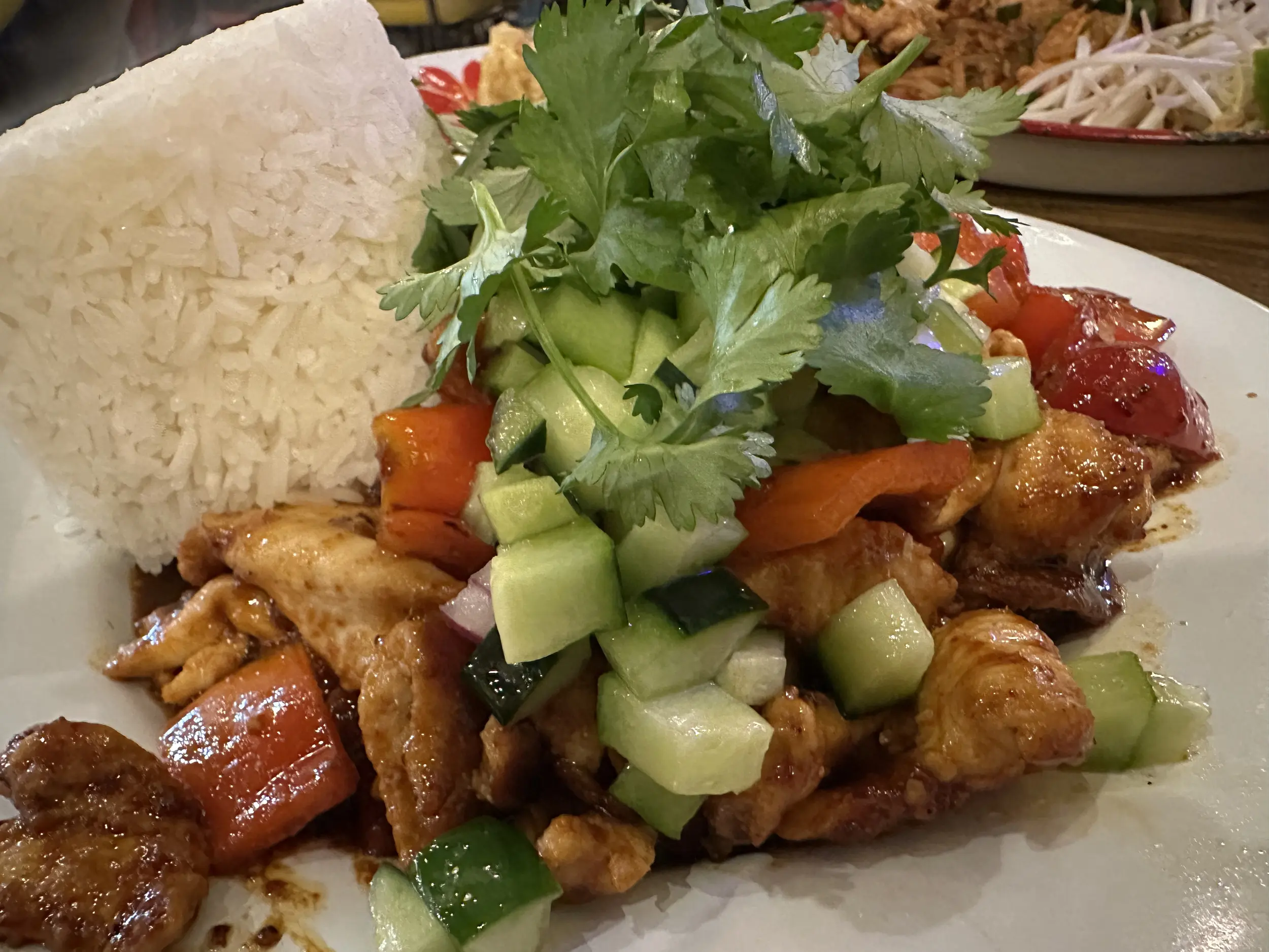 Photo of a thai dish with rice, chicken, and vegetables