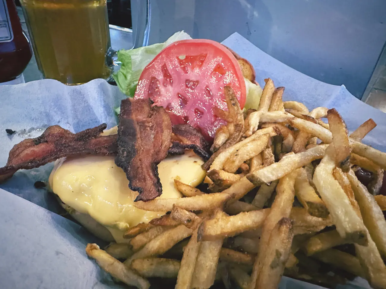 Photo of a burger, fries, and a beer