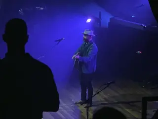 Photo of Drew Holcomb on stage