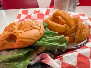 Photo of a burger with onion rings