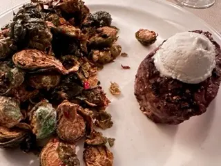 Close-up of deeply browned halved Brussels sprouts on a white plate