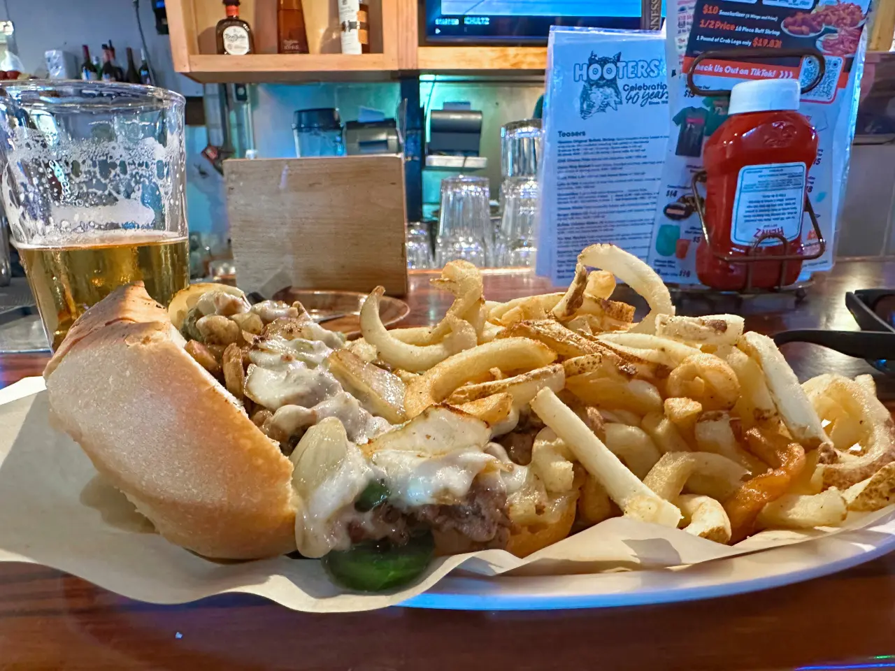 Photo of a philly steak, fries, and beer