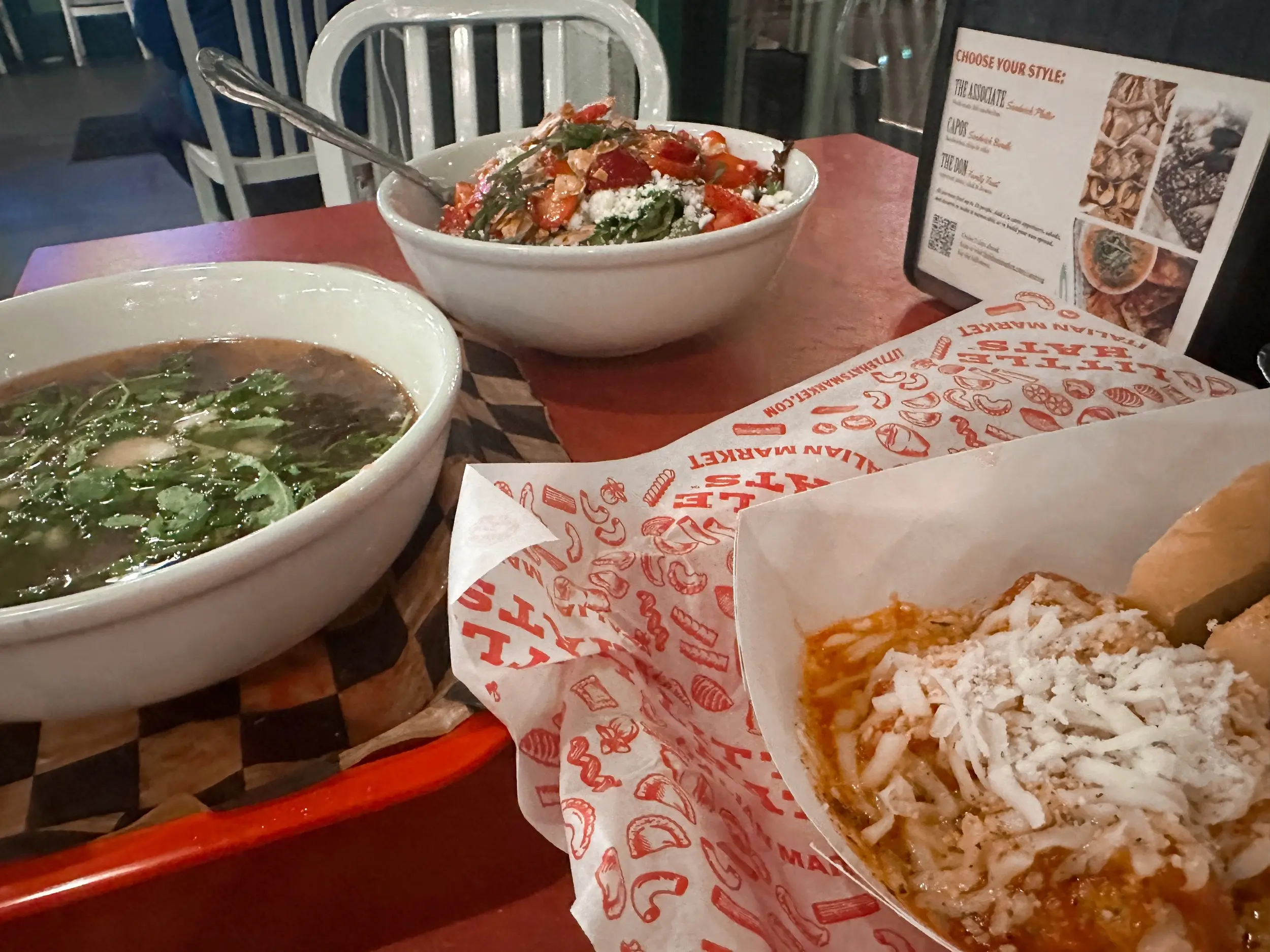 Photo of meatballs, soup, and a salad