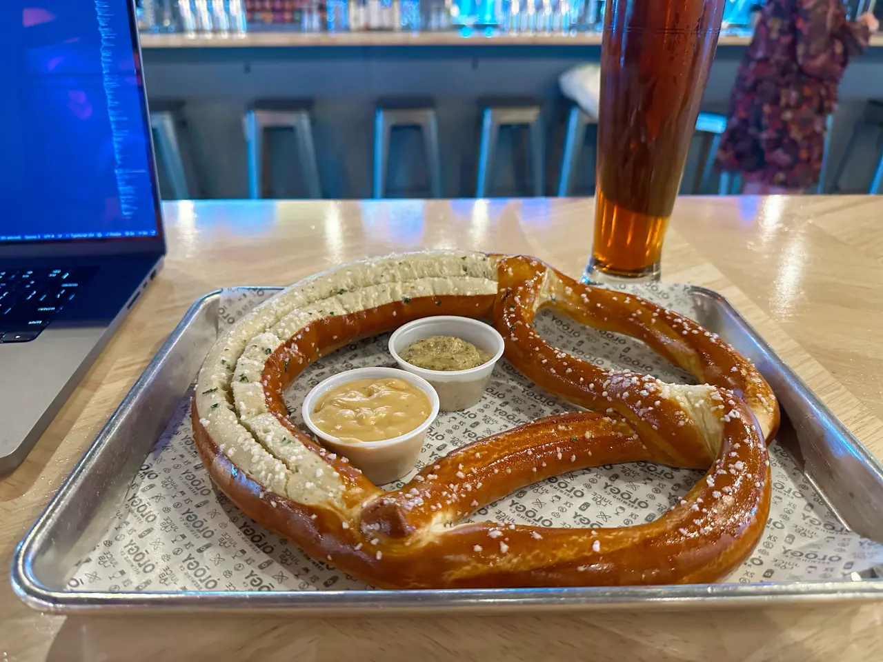 Photo of a large pretzel and a beer