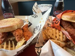 Photo of chicken tenders, a sandwich, and fries