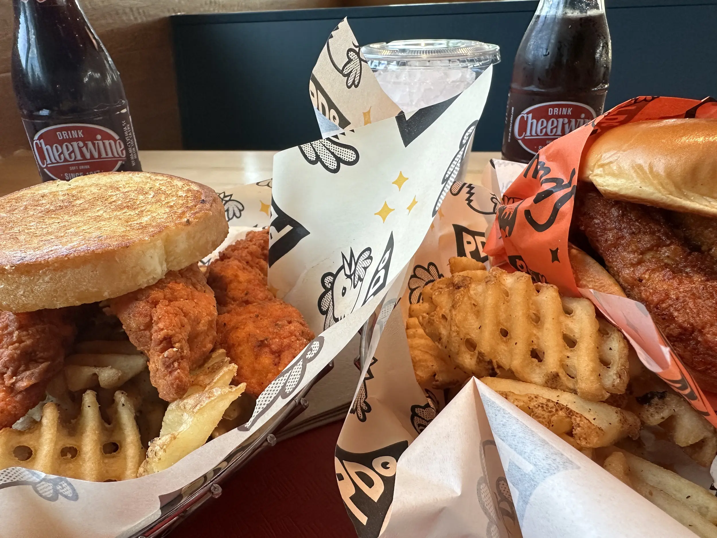 Photo of chicken tenders, a sandwich, and fries